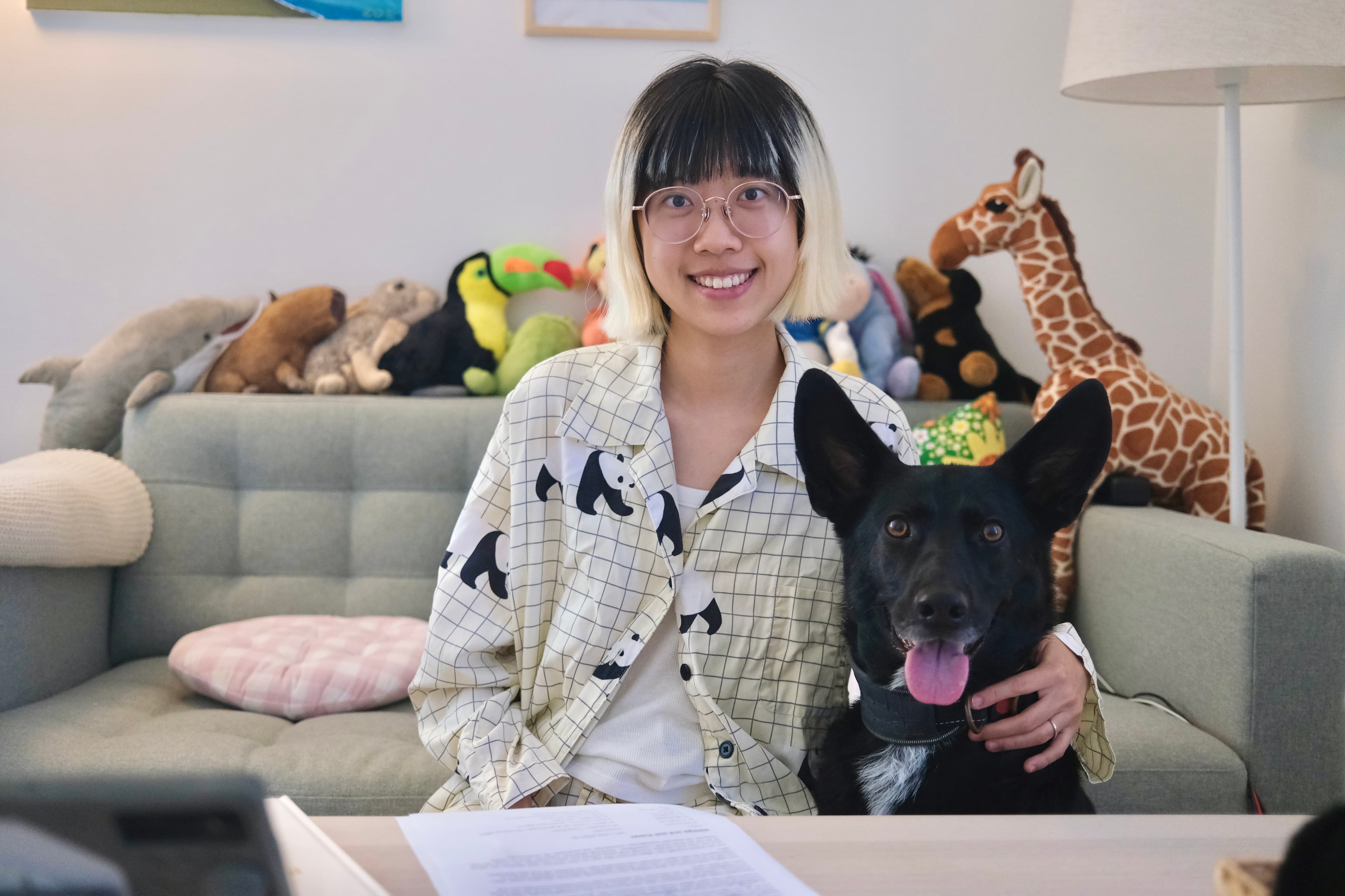 Zoe sitting beside a black dog during an individual behaviour session